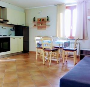 a kitchen and dining room with a table and chairs at Alloggio Turistico EDEN - Lubriano in Lubriano