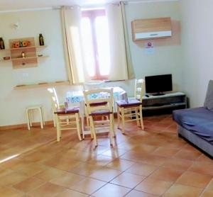 a living room with a table and chairs and a couch at Alloggio Turistico EDEN - Lubriano in Lubriano +8 photos