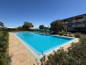 a large swimming pool in front of a building at Residenza Verde Blu - ArgonautiVacanze in Capoliveri +20 photos