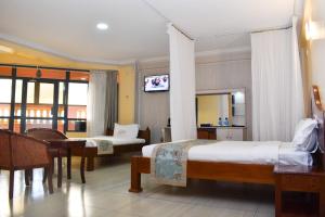 a hotel room with two beds and a television at Two Oceans Hotel Voi in Voi +34 photos