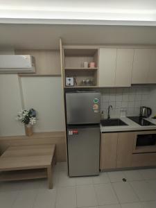 a small kitchen with a sink and a refrigerator at Fantasea Condo Kamala 1bdr in Kamala Beach