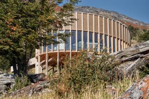 a building on top of a hill with a tree at Punto Cero Patagonia in Bahía Murta +21 photos