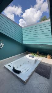 a bath tub sitting on top of a patio at chambre AZZURO avec jacuzzi lit rond et jardin avec piscine in Saint-Martial-sur-Né
