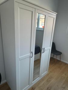 a white cabinet with a glass door in a room at Lossipargi Loft in Haapsalu +14 photos