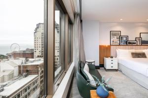 a bedroom with a bed and a large window at Hotel 1000, In The Unbound Collection By Hyatt in Seattle +207 photos