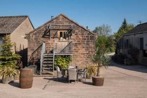 an old brick building with a table and chairs at The Damson Barn in Biddulph