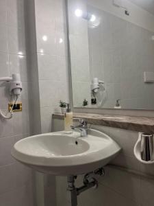 a bathroom with a sink and a large mirror at Casa Katy in Garda +29 photos