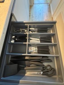 a drawer with scissors and other utensils in it at Lossipargi Loft in Haapsalu