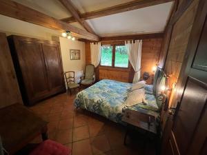 a small bedroom with a bed and a window at Chambre D'hôtes Du Mas in Saint-Vitte-sur-Briance