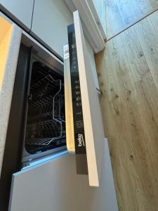 an oven with its door open in a kitchen at Lossipargi Loft in Haapsalu