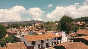 a view of a town with houses and roofs at Tapalpa Hotel Casa Colibrí in Tapalpa