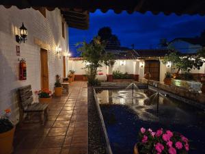 a house with a pond in the yard at night at Tapalpa Hotel Casa Colibrí in Tapalpa