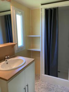 a bathroom with a sink and a shower at Camping 3 étoiles - Piscine - ccbfghc in Mamers +7 photos