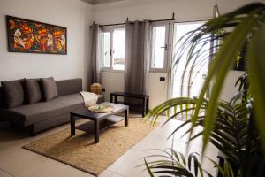 a living room with a couch and a table at Live Puertito Neptune Beach in Puertito de Güímar