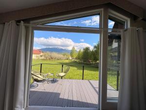 a sliding glass door to a deck with a view at Green Lodge Bran in Bran