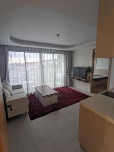 a living room with a couch and a table at 2BR Fantasea condo kamala in Kamala Beach
