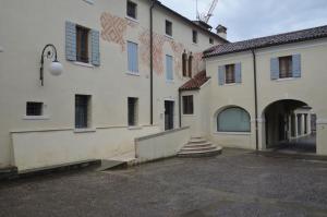 a large white building with a staircase next to it at La Spiga apartment near Venice in Noale