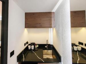 a kitchen with a sink and a counter top at The Crossway Hotel, Coventry Walsgrave, Part of AG Collection in Coventry +15 photos