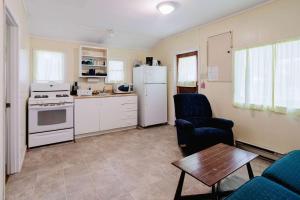 a kitchen with a refrigerator and a table and chairs at 2-Bedroom Cottage #1 - Ambleside in Kawartha Lakes