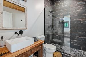a bathroom with a sink and a toilet and a shower at Standing Rock Farms in Madison +61 photos