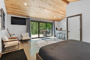 a bedroom with a large bed and a large window at Standing Rock Farms in Madison