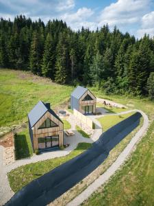 an overhead view of two wooden buildings in a field at Łyse Stodoły in Mordarka