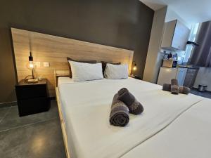 a bedroom with a large bed with towels on it at Mingles Suites in Il-Gżira +17 photos