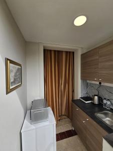 a kitchen with a microwave on top of a refrigerator at Mingles Suites in Il-Gżira