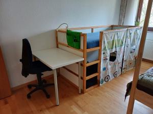 a bedroom with a desk and a bunk bed with a desk and a desk at Forstoase Deister in Bredenbeck
