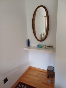 a room with a mirror on a wall and a shelf at Forstoase Deister in Bredenbeck +19 photos
