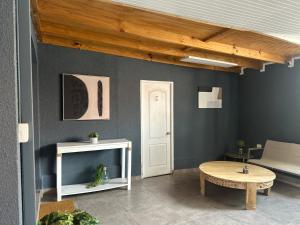 a living room with a table and a white door at Casa full in Santiago