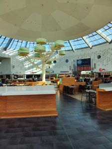 a shopping mall with tables and chairs and windows at Emmas FEWO in Bremen