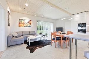 a living room with a couch and a table at Rukkilille majutus in Herjava