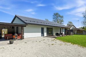 a house with a patio and a yard at Rukkilille majutus in Herjava