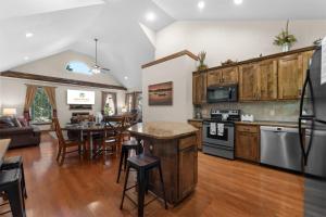 a kitchen and living room with a table and chairs at Hickory Hideaway with Communal Pool Access in Hollister