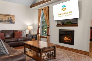 a living room with a couch and a fire place at Hickory Hideaway with Communal Pool Access in Hollister
