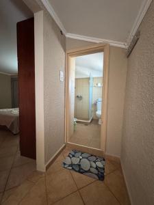 a bathroom with a door open to a bathroom with a toilet at Dora sarti in Sarti
