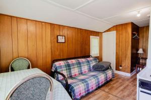 a living room with a couch and a bed at 1-Bedroom Cottage #2 - Ambleside in Kawartha Lakes