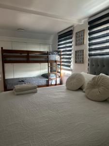 a bedroom with a bed with two bunk beds at Casa full in Santiago