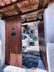 a wooden door in the side of a building at Leos Traditional Holiday House in Leonidio