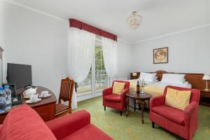 a hotel room with a bed and a table and chairs at Chimera Spa Niechorze in Niechorze