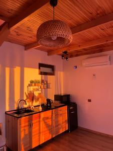a kitchen with a sink and a counter in a room at Skidala Cottage in Batumi