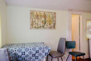 a room with a table and chairs and a painting on the wall at Ambleside - 1-Bedroom Cottage #3 in Kawartha Lakes