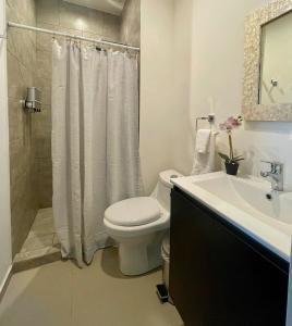 a white bathroom with a toilet and a sink at La Jolla in Bejuco +7 photos
