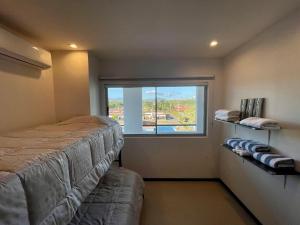 a bedroom with a bed and a large window at La Jolla in Bejuco