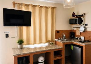 a kitchen with a sink and a shower curtain at Habitación arena, Paseo Durango in Durango