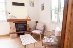 a living room with a fireplace and a chair at Parnaydisiaque in Parnay