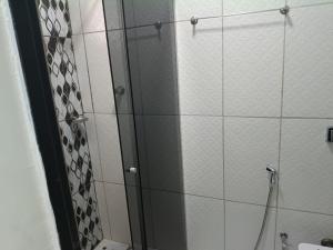 a shower with a glass door in a bathroom at Casa no centro de Brumadinho in Brumadinho +25 photos