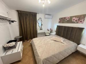 a bedroom with a bed and a table and a window at Dora sarti in Sarti