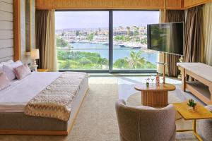 a hotel room with a bed and a large window at Cesme Sarezya Luxury Boutique Hotel in Çeşme +184 photos